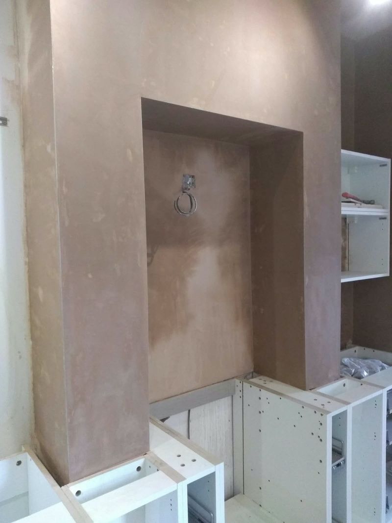 Plastered chimney breast alcove above new kitchen base units