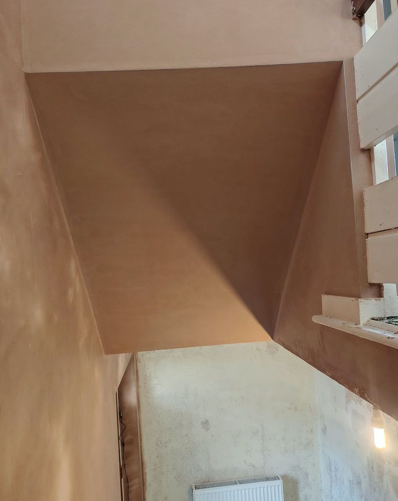 Freshly plastered bulkhead and walls over a staircase