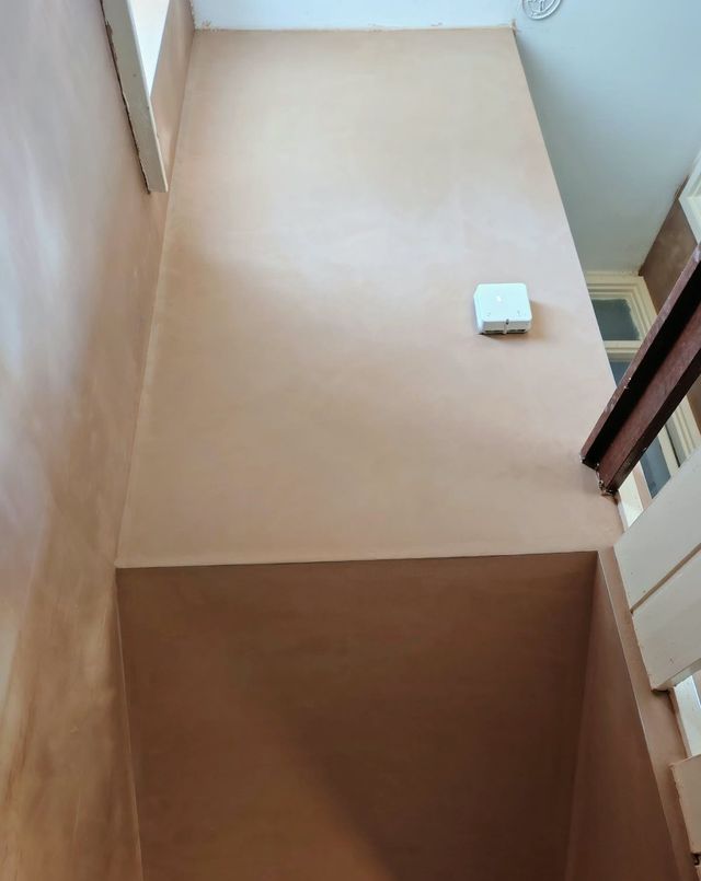 Stairwell with freshly plastered walls and ceiling