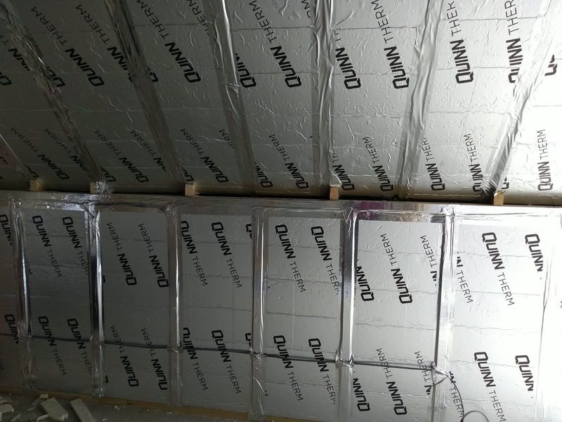 Foil-faced insulation boards fitted between roof rafters and walls