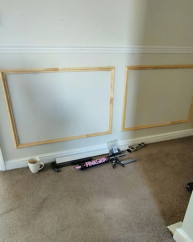 Decorative wall panelling being fitted to a painted wall